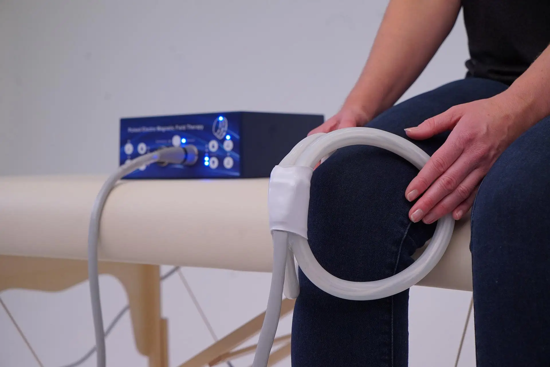 PEMF coil around a seated person's knee