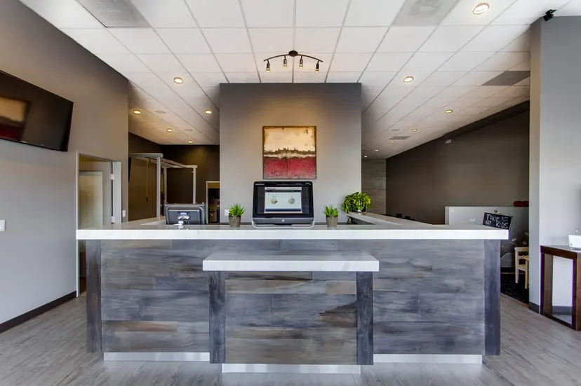 Clinic reception desk and modern waiting area at True Chiropractic