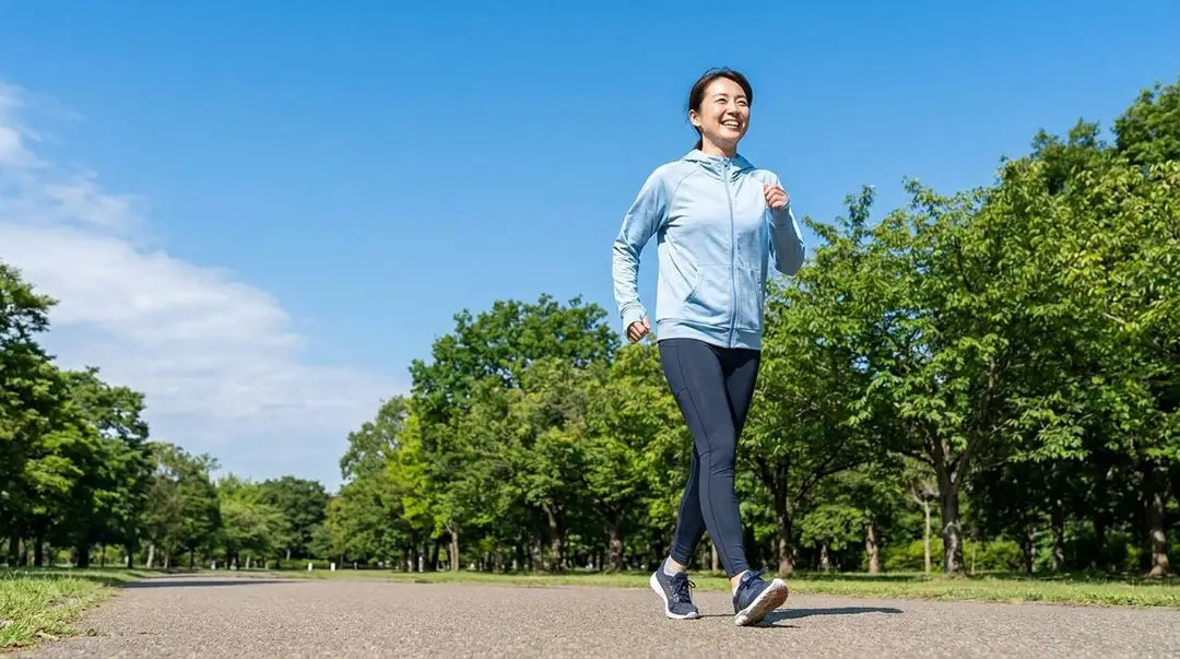 Smiling woman walking briskly on a park path